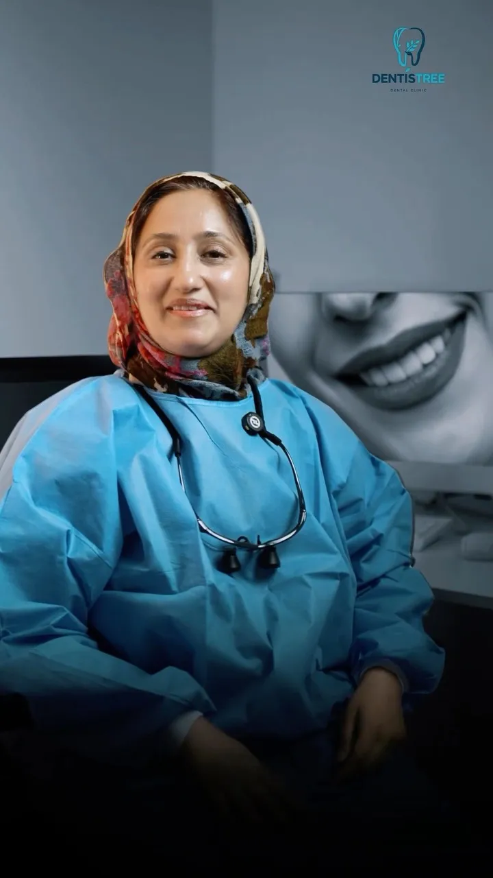 Dr. Rifat in blue scrubs with a stethoscope